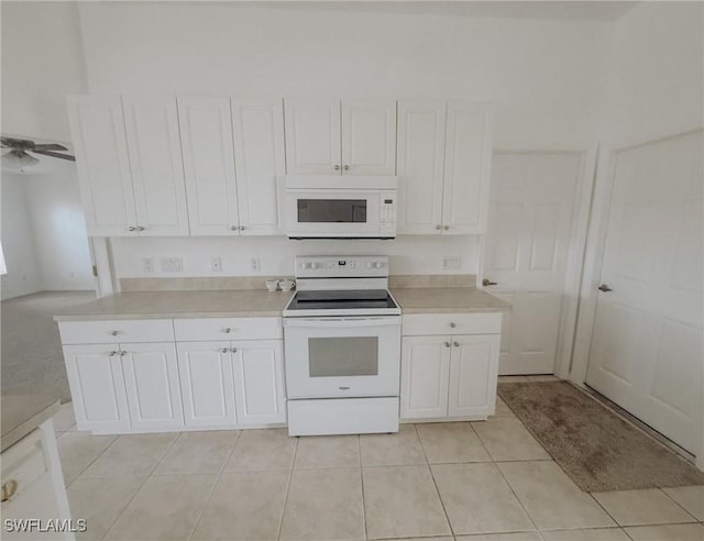 kitchen with white cabinets, white appliances, and light countertops