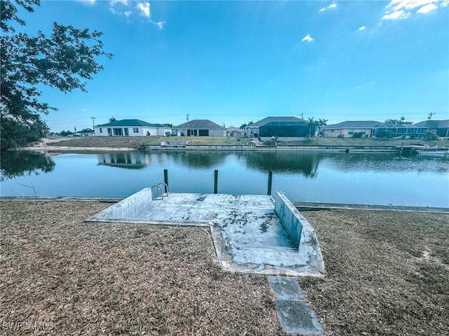 view of dock with a water view and a residential view