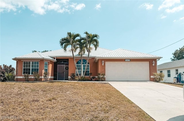 single story home with concrete driveway, a standing seam roof, metal roof, stucco siding, and a garage