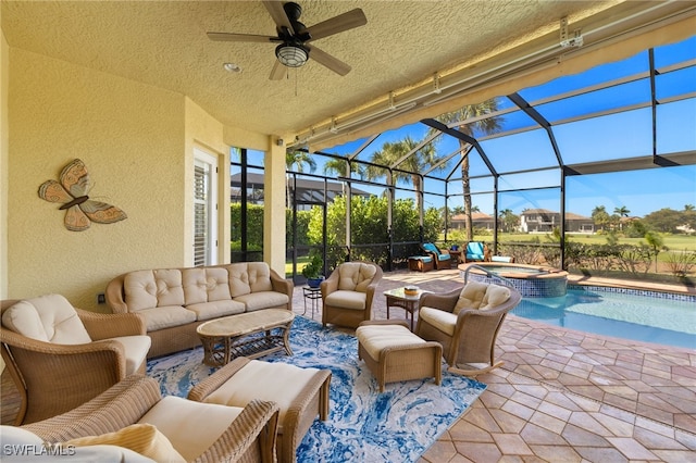 view of patio with a lanai, outdoor lounge area, a ceiling fan, and a pool with connected hot tub