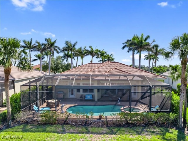 view of pool with a lanai, a patio, and a pool with connected hot tub