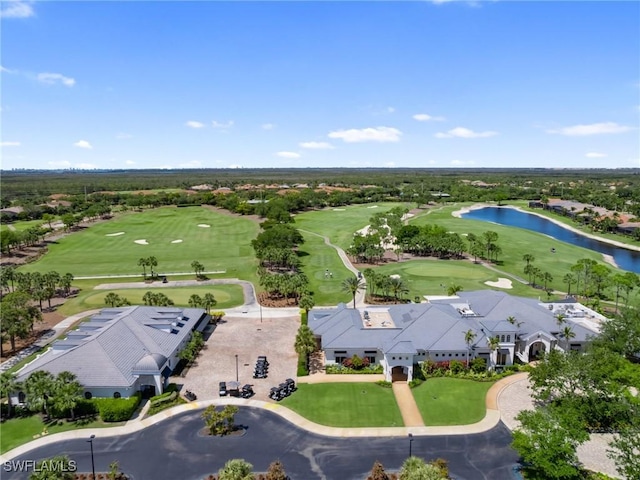 birds eye view of property featuring golf course view and a water view