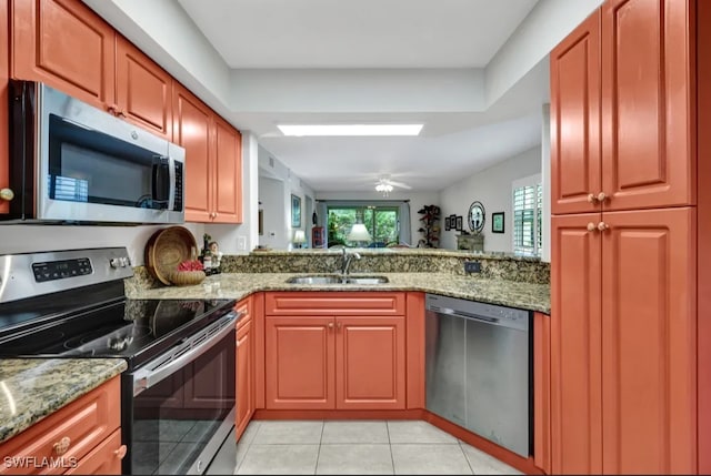 26693 Little John Ct Unit 70, Bonita Springs, FL 34135 - kitchen featuring stainless steel appliances, a sink, light tile patterned flooring, light stone countertops, and a peninsula