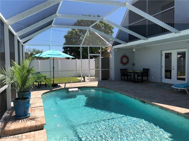411 SW 34th Ter, Cape Coral, FL 33914 - view of swimming pool featuring french doors, a patio area, ceiling fan, and glass enclosure