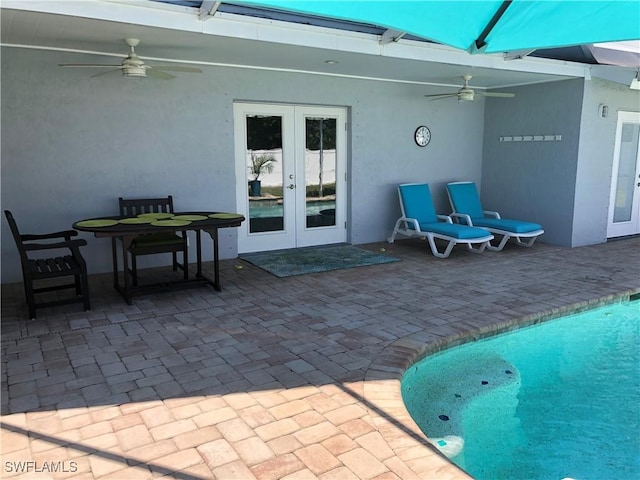 411 SW 34th Ter, Cape Coral, FL 33914 - view of patio featuring french doors, a ceiling fan, and an outdoor pool