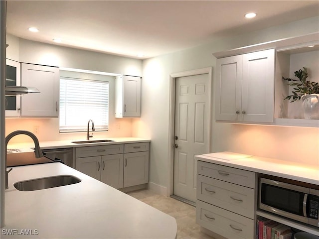 411 SW 34th Ter, Cape Coral, FL 33914 - kitchen with a sink, stainless steel microwave, light countertops, recessed lighting, and gray cabinets