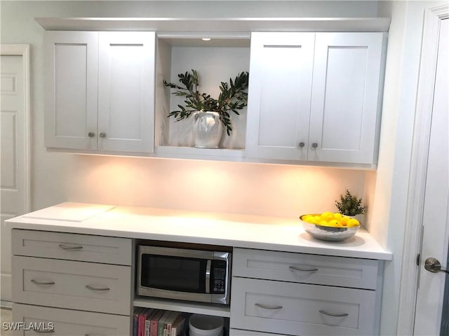 411 SW 34th Ter, Cape Coral, FL 33914 - kitchen featuring stainless steel microwave, light countertops, gray cabinets, and white cabinetry