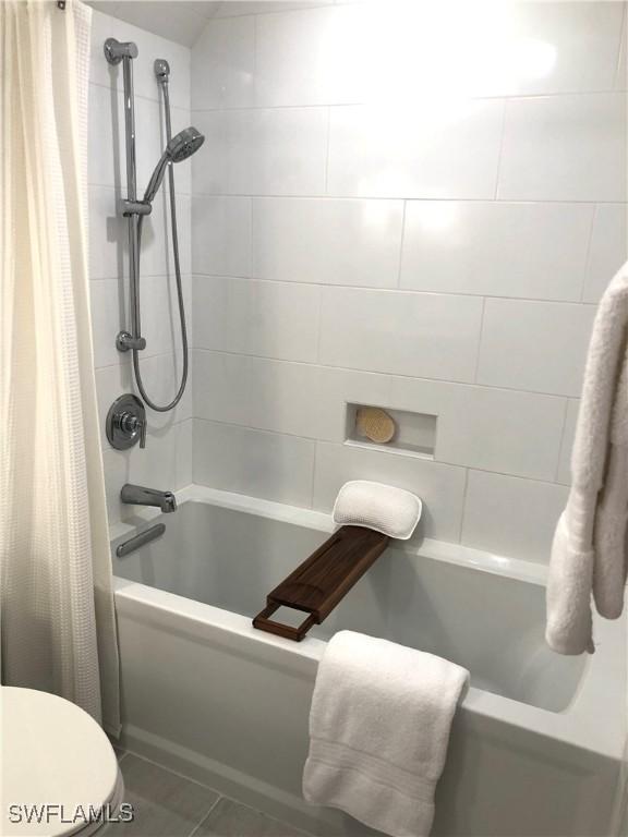 411 SW 34th Ter, Cape Coral, FL 33914 - full bath with shower / bath combination with curtain, toilet, and tile patterned flooring