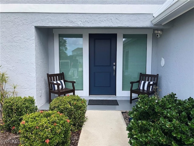 411 SW 34th Ter, Cape Coral, FL 33914 - property entrance with stucco siding and a porch