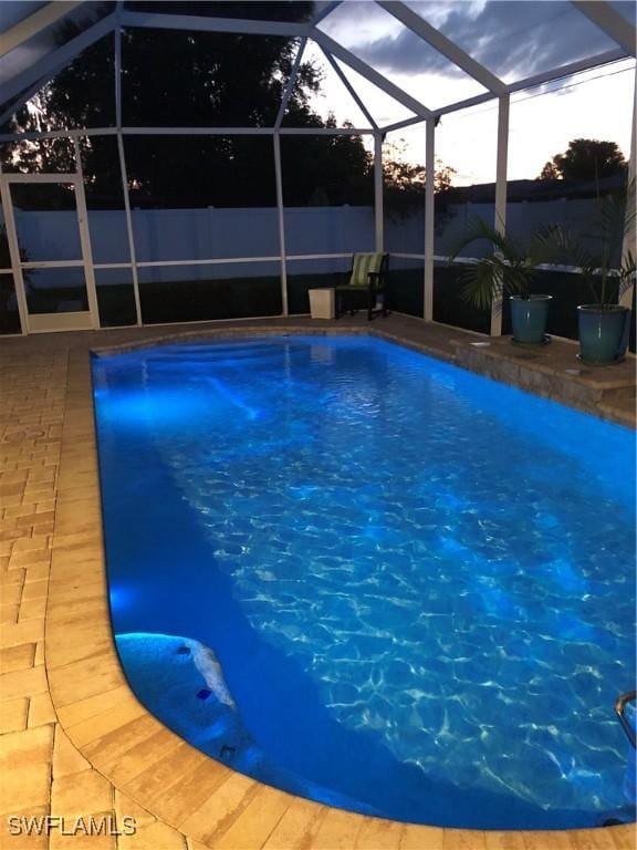411 SW 34th Ter, Cape Coral, FL 33914 - view of swimming pool with glass enclosure and a patio