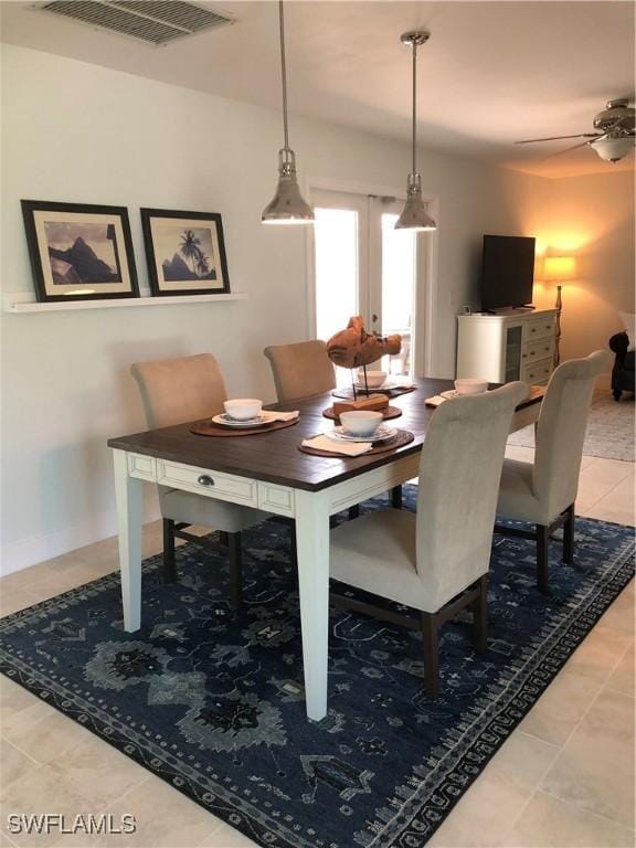 411 SW 34th Ter, Cape Coral, FL 33914 - dining area with light tile patterned floors, ceiling fan, french doors, and baseboards
