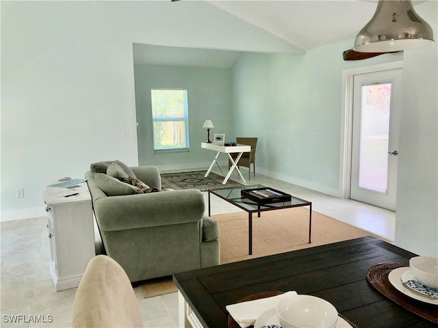 411 SW 34th Ter, Cape Coral, FL 33914 - living room with vaulted ceiling and baseboards