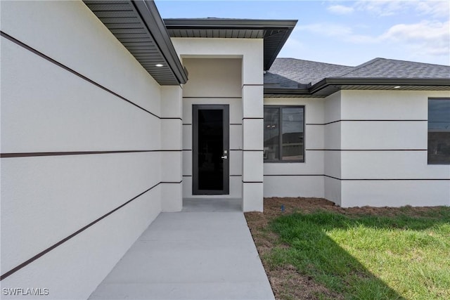 5327 Beauty St, Lehigh Acres, FL 33971 - property entrance with stucco siding and a shingled roof