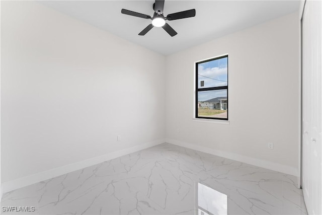 5327 Beauty St, Lehigh Acres, FL 33971 - spare room featuring marble finish floor, baseboards, and a ceiling fan