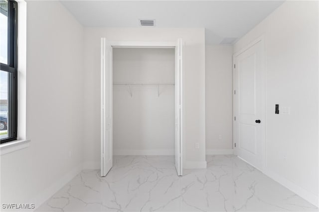 5327 Beauty St, Lehigh Acres, FL 33971 - unfurnished bedroom featuring visible vents, baseboards, marble finish floor, and a closet