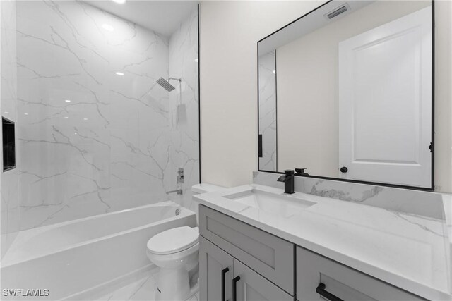 5327 Beauty St, Lehigh Acres, FL 33971 - full bath with vanity, marble finish floor, shower / bath combination, toilet, and visible vents