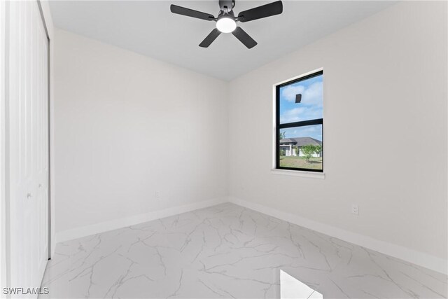 5327 Beauty St, Lehigh Acres, FL 33971 - unfurnished room featuring marble finish floor, baseboards, and a ceiling fan