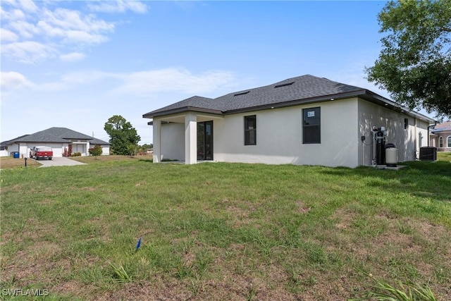 5327 Beauty St, Lehigh Acres, FL 33971 - back of property with stucco siding and a lawn