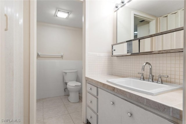 2244 Winkler Ave Unit 110, Fort Myers, FL 33901 - bathroom with tile walls, toilet, wainscoting, vanity, and tile patterned flooring