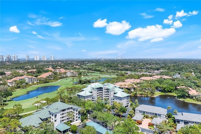 birds eye view of property with a water view and view of golf course