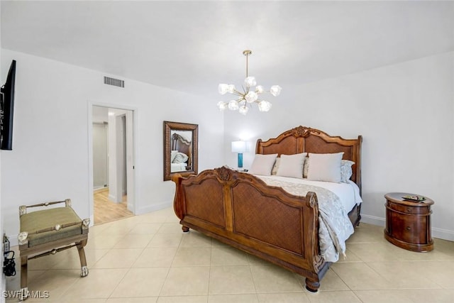 bedroom with a chandelier, light tile patterned floors, baseboards, and visible vents