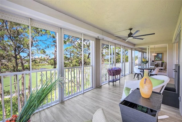 sunroom / solarium with a textured ceiling and wood finished floors