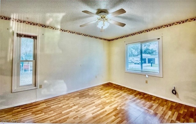 21070 Delake Ave, Port Charlotte, FL 33954 - spare room featuring wood finished floors, baseboards, and a ceiling fan