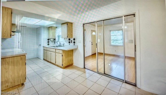 21070 Delake Ave, Port Charlotte, FL 33954 - bathroom with a skylight, tile patterned floors, wallpapered walls, and vanity