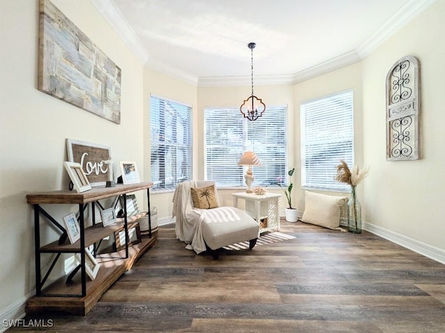 sitting room with a chandelier, dark wood-style flooring, baseboards, and ornamental molding
