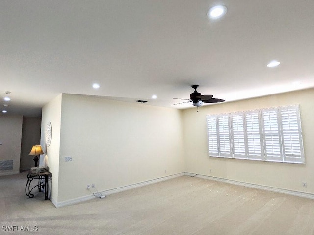 carpeted spare room featuring recessed lighting, visible vents, baseboards, and ceiling fan