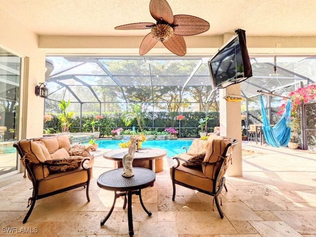 view of patio featuring an outdoor pool, an outdoor living space, ceiling fan, and glass enclosure