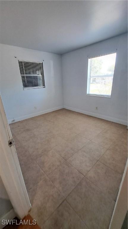 509 W Obispo Ave, Clewiston, FL 33440 - tiled empty room with baseboards