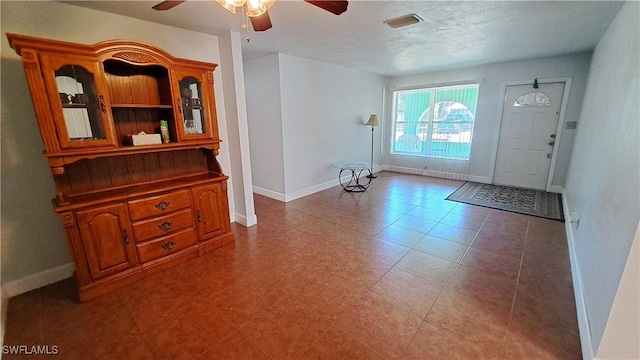 509 W Obispo Ave, Clewiston, FL 33440 - foyer with baseboards, a textured ceiling, ceiling fan, and visible vents