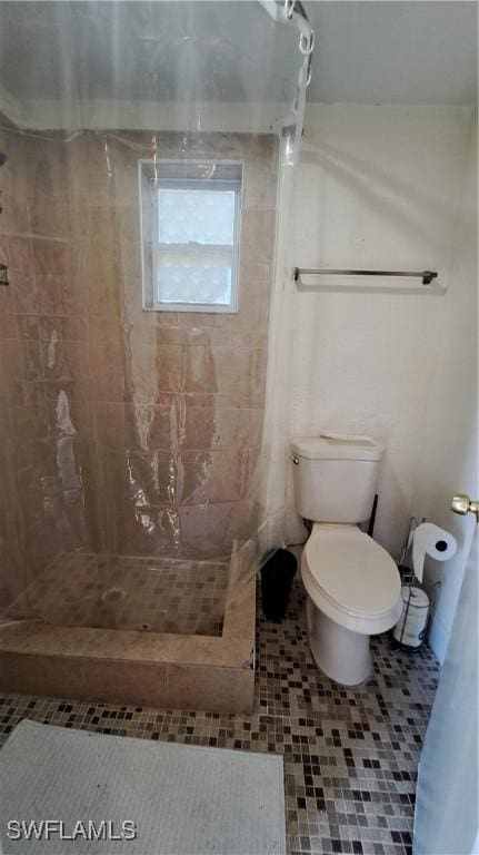 509 W Obispo Ave, Clewiston, FL 33440 - bathroom with tile patterned floors, a stall shower, and toilet