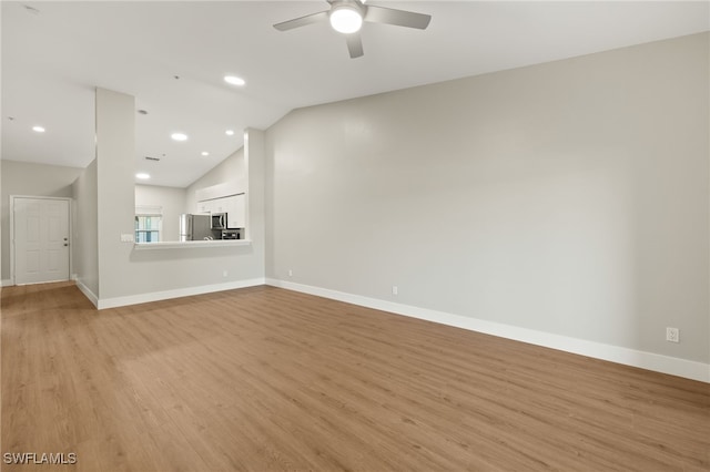 9200 Highland Woods Blvd Unit 1309, Bonita Springs, FL 34135 - unfurnished living room with light wood-type flooring, ceiling fan, baseboards, and lofted ceiling