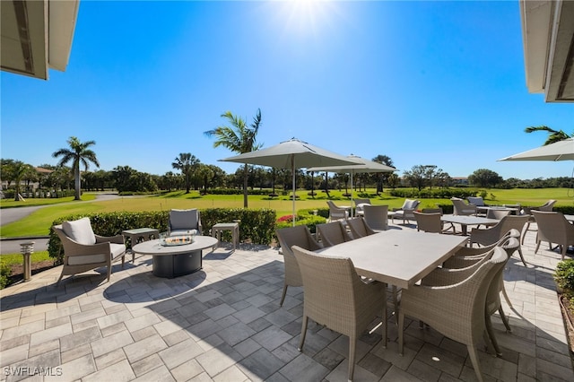 9200 Highland Woods Blvd Unit 1309, Bonita Springs, FL 34135 - view of patio with view of golf course, a fire pit, and outdoor dining space
