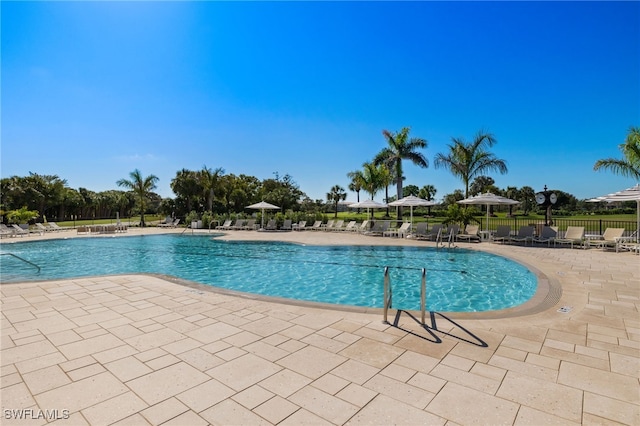 9200 Highland Woods Blvd Unit 1309, Bonita Springs, FL 34135 - community pool with a patio area and fence