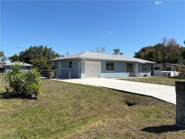 view of front facade with a garage, a front lawn, fence, stucco siding, and driveway