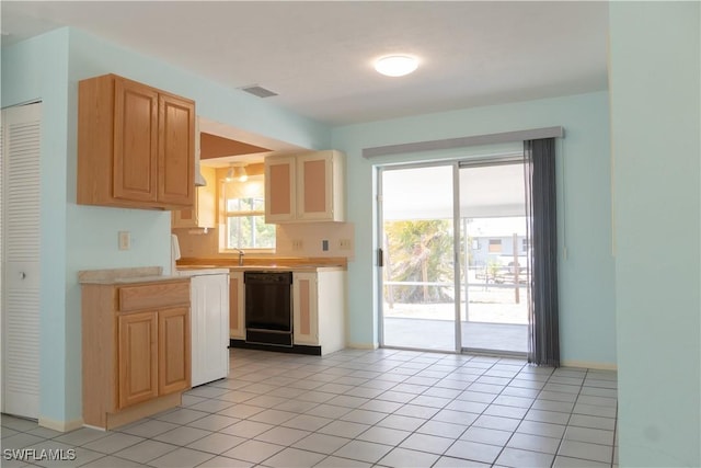 kitchen featuring visible vents, light countertops, dishwasher, and light tile patterned flooring