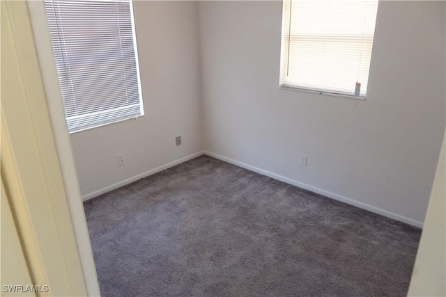 carpeted empty room with baseboards