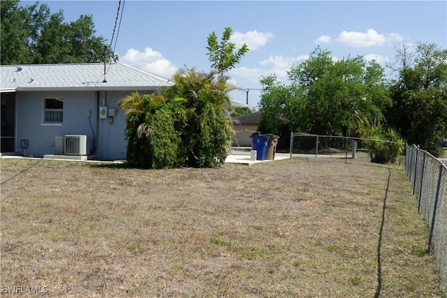 view of yard with fence and cooling unit