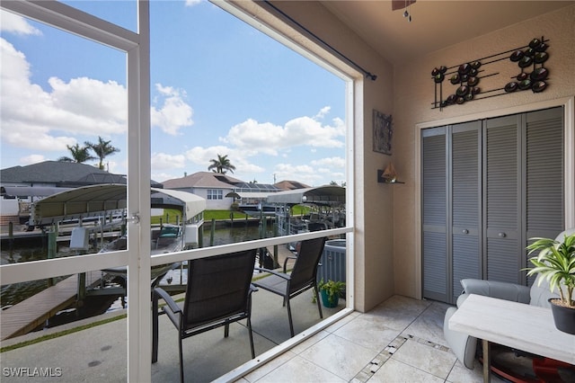 1315 SW 47th Ter Unit 102, Cape Coral, FL 33914 - balcony featuring boat lift, a dock, a water view, and a residential view