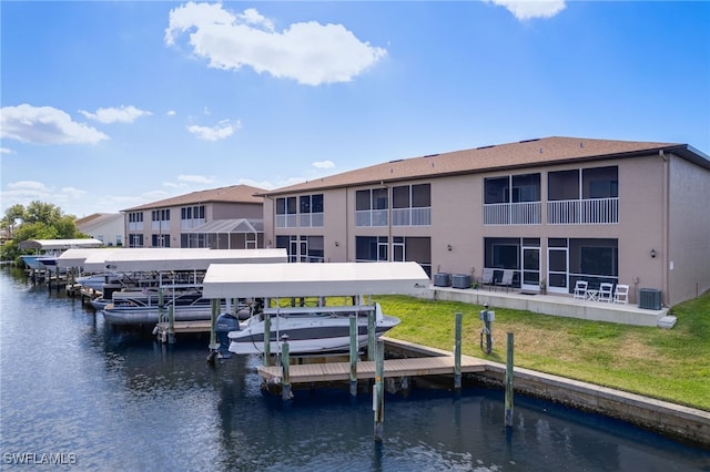 1315 SW 47th Ter Unit 102, Cape Coral, FL 33914 - dock with boat lift, a water view, cooling unit, and a yard