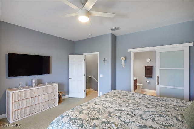 1315 SW 47th Ter Unit 102, Cape Coral, FL 33914 - bedroom with light carpet, baseboards, ensuite bath, and ceiling fan