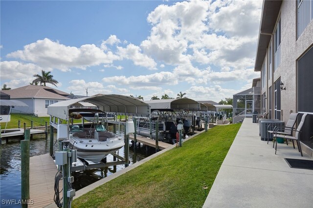 1315 SW 47th Ter Unit 102, Cape Coral, FL 33914 - dock area featuring boat lift, a water view, and a lawn