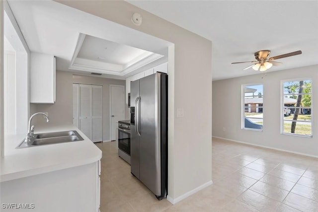 6874 Carmelle Dr, Fort Myers, FL 33919 - kitchen with stainless steel appliances, a sink, light countertops, a tray ceiling, and white cabinetry