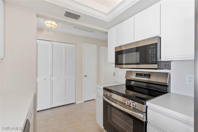 6874 Carmelle Dr, Fort Myers, FL 33919 - kitchen featuring appliances with stainless steel finishes, light countertops, light tile patterned flooring, and white cabinets