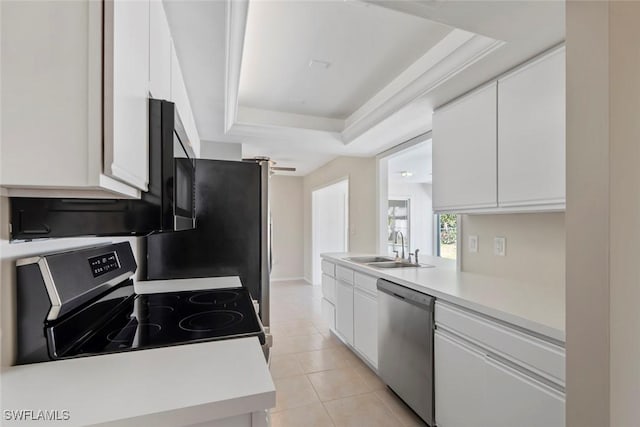 6874 Carmelle Dr, Fort Myers, FL 33919 - kitchen with appliances with stainless steel finishes, a sink, a raised ceiling, white cabinets, and light countertops