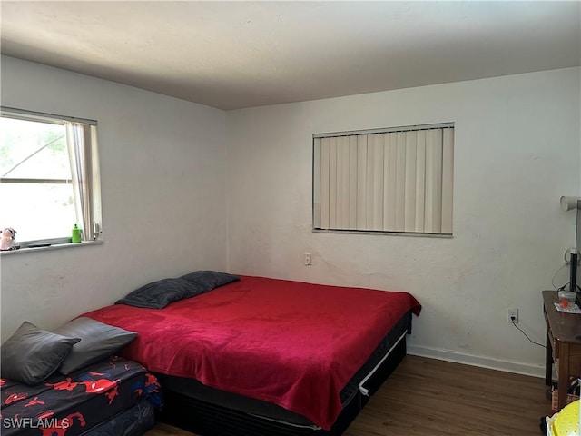 bedroom featuring baseboards and wood finished floors