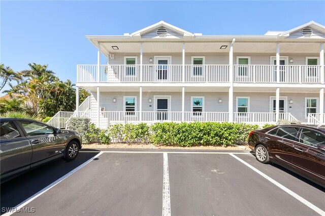 829 W Elkcam Cir Unit 2-106, Marco Island, FL 34145 - view of building exterior with uncovered parking